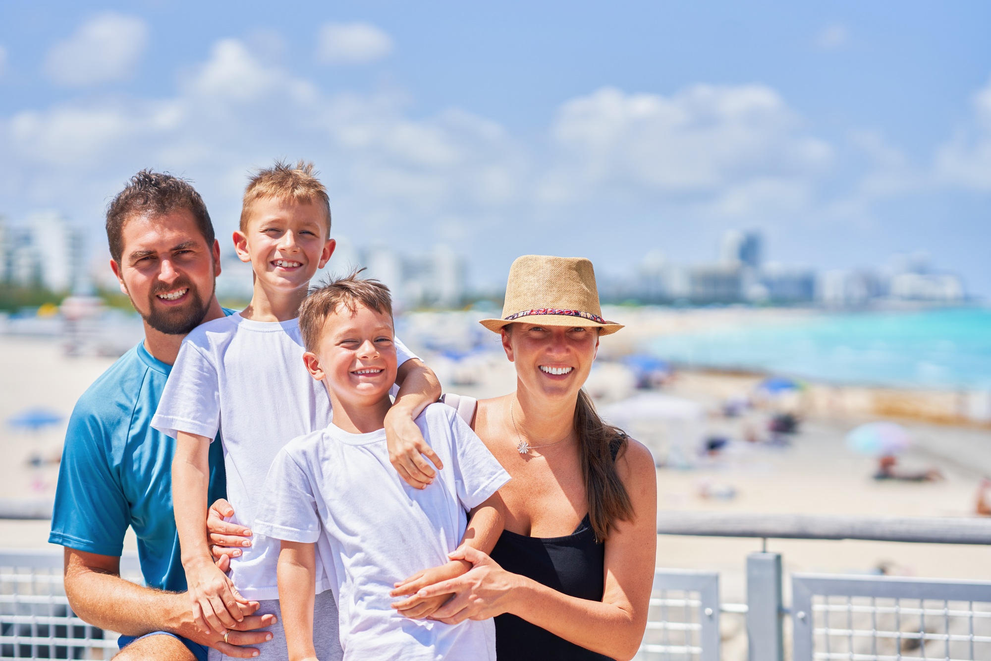 A happy family is enjoying their beach vacation in Miami with a beautiful view of the ocean