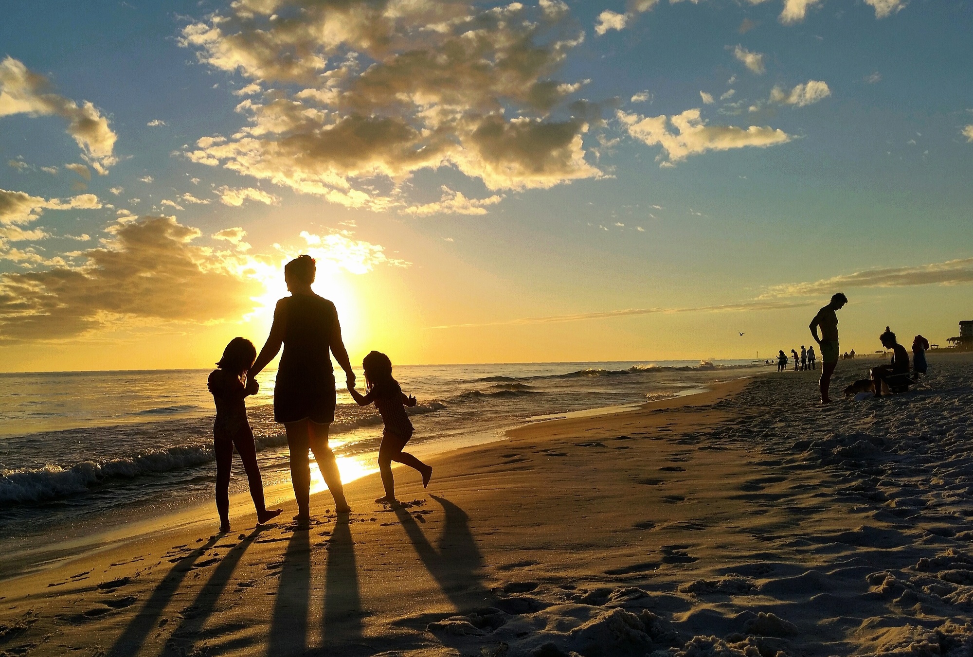 Beautiful sky at sunset perfect for family fun on beach vacation in Florida with clouds in blue sky.
