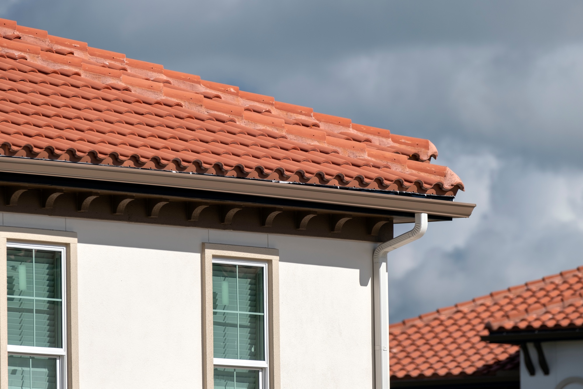 Condo Coverage Requirements. Tiled roof covering of condo building in Florida. Closeup of house rooftop