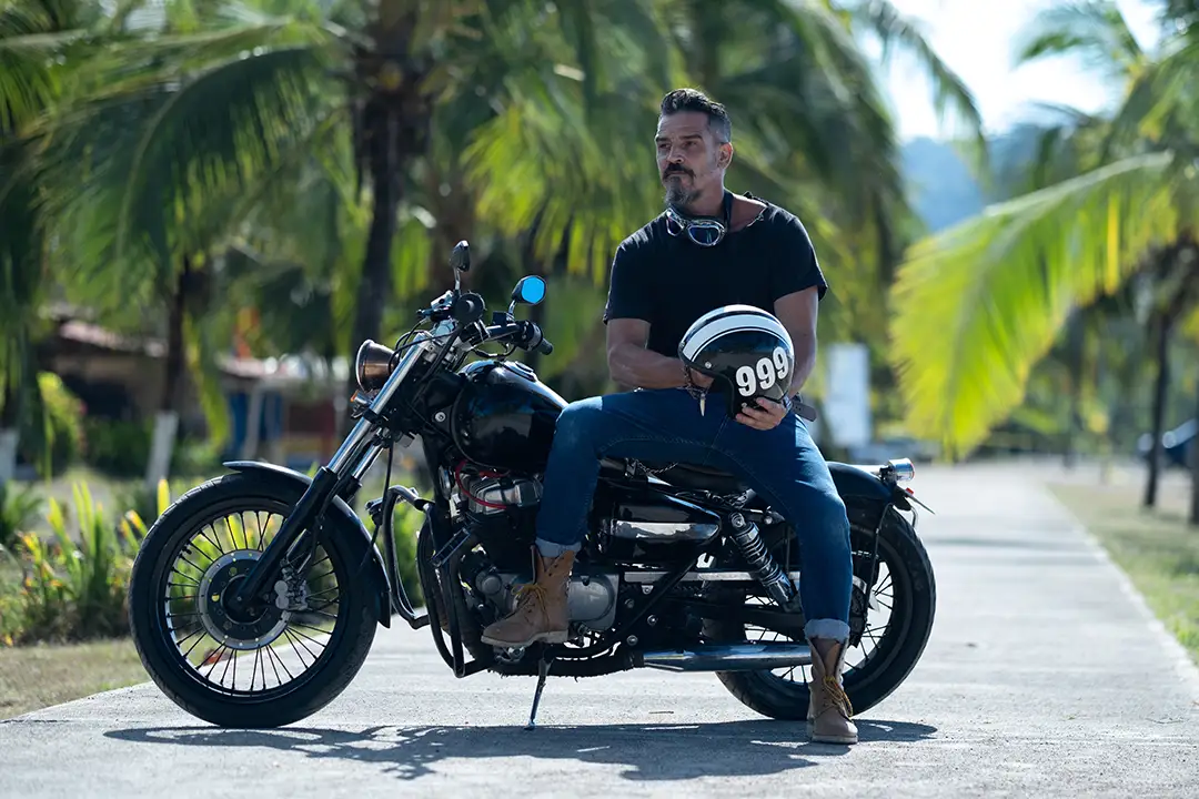 male-biker-with-thick-beard-poses-motorbike-beautiful-park copy